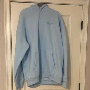 Soft Light Blue Pullover Hoodie with Subtle Chest Logo